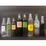 Eight assorted glass oil bottles including Solvol, five with original caps.