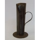 A Castrollo glass and tin measuring jug, for dispensing upper cylinder lubricant.