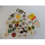 A quantity of mixed advertising motoring badges and key rings.