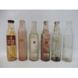 Six mixed glass oil bottles.