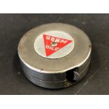 A Germ Oils metal tape measure.