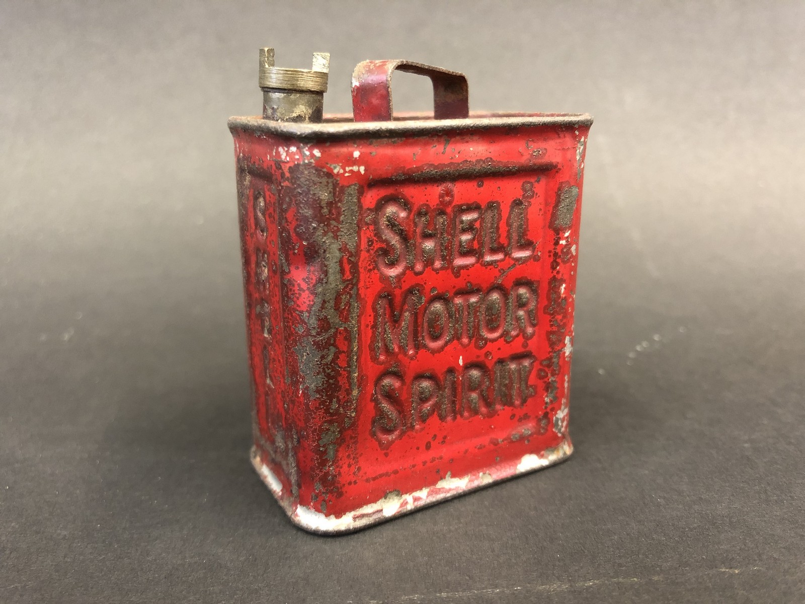 A Shell Motor Spirit miniature perfume container in the shape of a two gallon petrol can.