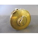 An AA circular brass tape measure.