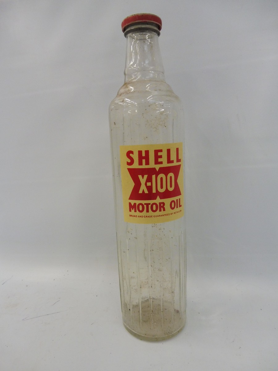 A Shell X-100 glass quart oil bottle.