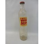 A Shell X-100 glass quart oil bottle.