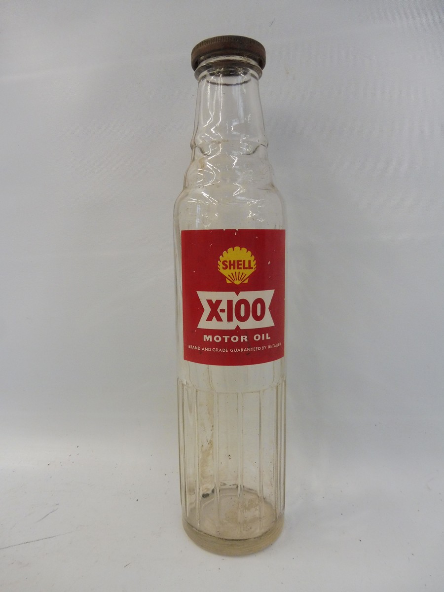 A Shell X-100 glass oil bottle.