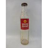A Shell X-100 glass oil bottle.