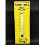 A Duckham's Oils enamel thermometer in near mint condition, 12 x 36".