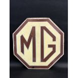 An MG hardboard advertising sign, 16 1/2 x 16 1/2".