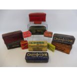 Eight spark plug tins including Sphinx and Champion, also small fuse tins etc.