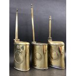 Three Continental polished brass oval oilers with long spouts, one stamped 'D.R.G.M D.R.P. angem'.