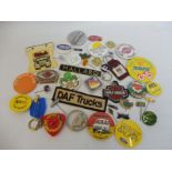 A quantity of mixed petrol, oil and other garage related badges and key rings.