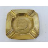 A polished brass Bugatti ashtray.