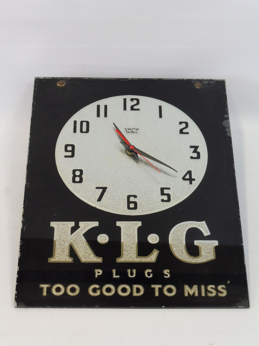 A K.L.G. Plugs advertising glass fronted wall clock by Smith Sectric, 10 1/2 x 14".