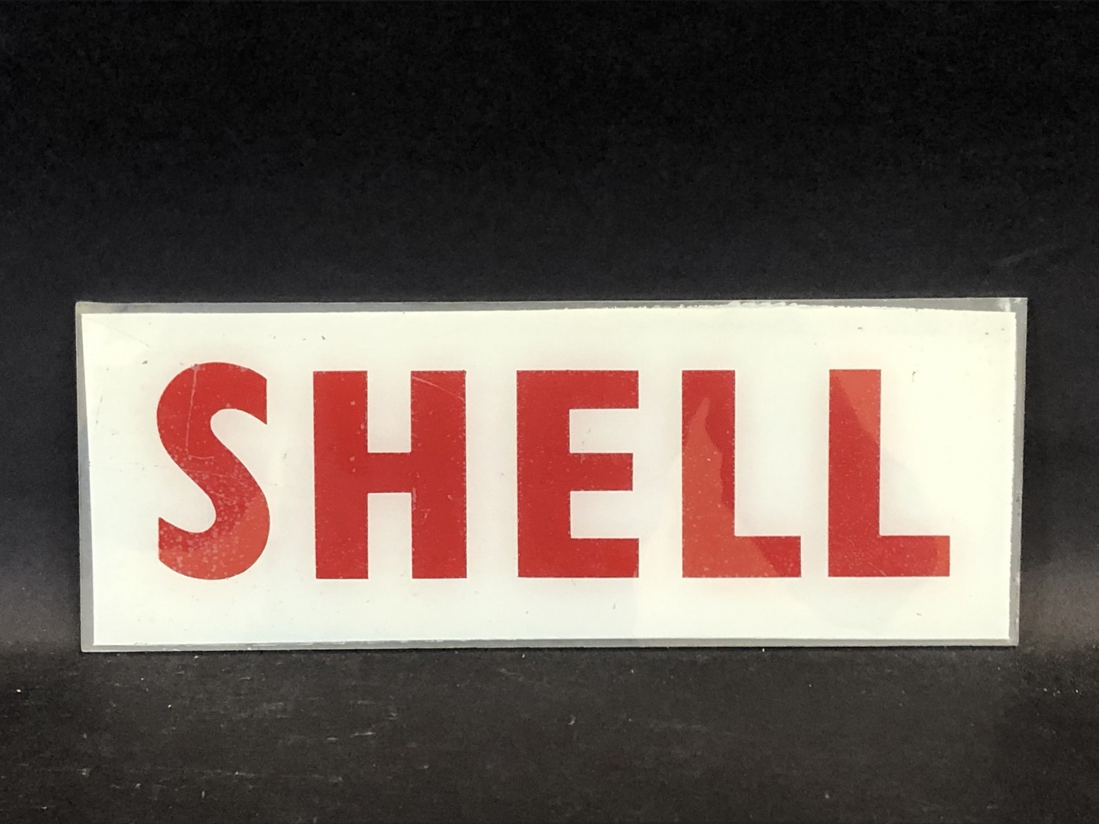 A small Shell glass petrol pump brand insert, 11 x 4 1/4".