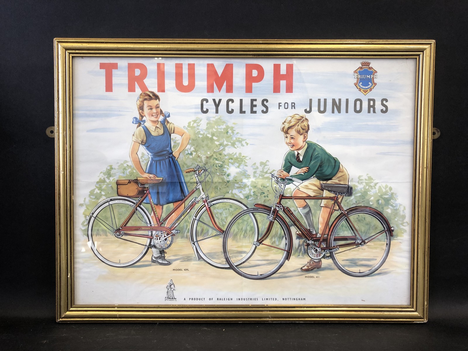 A 'Triumph Cycles for Juniors' pictorial framed poster, 20 1/2 x 15 3/4".