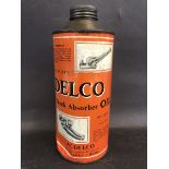 A Delco Shock Absorber Oil cylindrical quart can of bright colour.