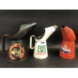 A Silver Knight half gallon measure, a BP Lubricants quart measure and another for Amoco.