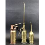 Three polished brass oilers, the tallest stamped 'Pressol' to the base.