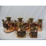 A rare set of six copper and brass mounted weights and measures and fuel canisters, all stamped