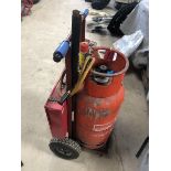 A gas bottle trolley with professional gas torch kit plus brass rods etc.