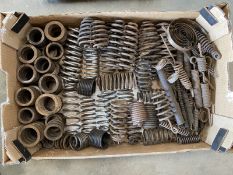 A large tray of springs for vintage motorcycle girder forks and seat frames.