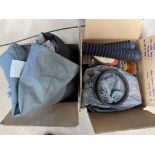 A box of bike covers, motorcycle security equipment etc.