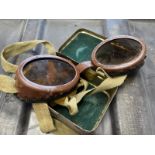 A pair of vintage military motorcycle goggles, in original tin case.