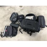 A quantity of panniers and motorcycle bags.