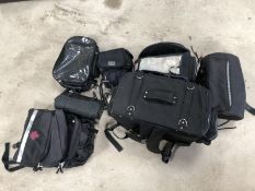 A quantity of panniers and motorcycle bags.