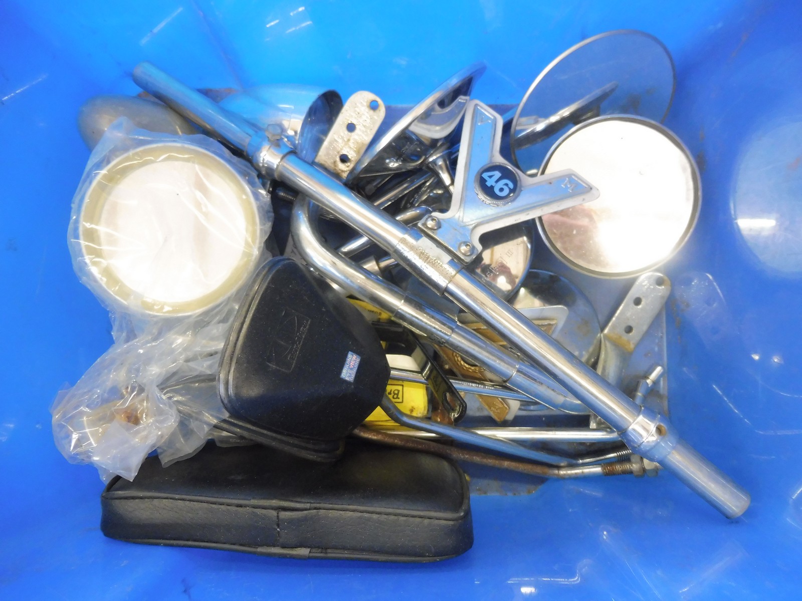 A box of mixed badge bars and wing mirrors.