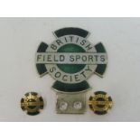 A British Field Sports Society enamel car badge and two matching lapel badges.