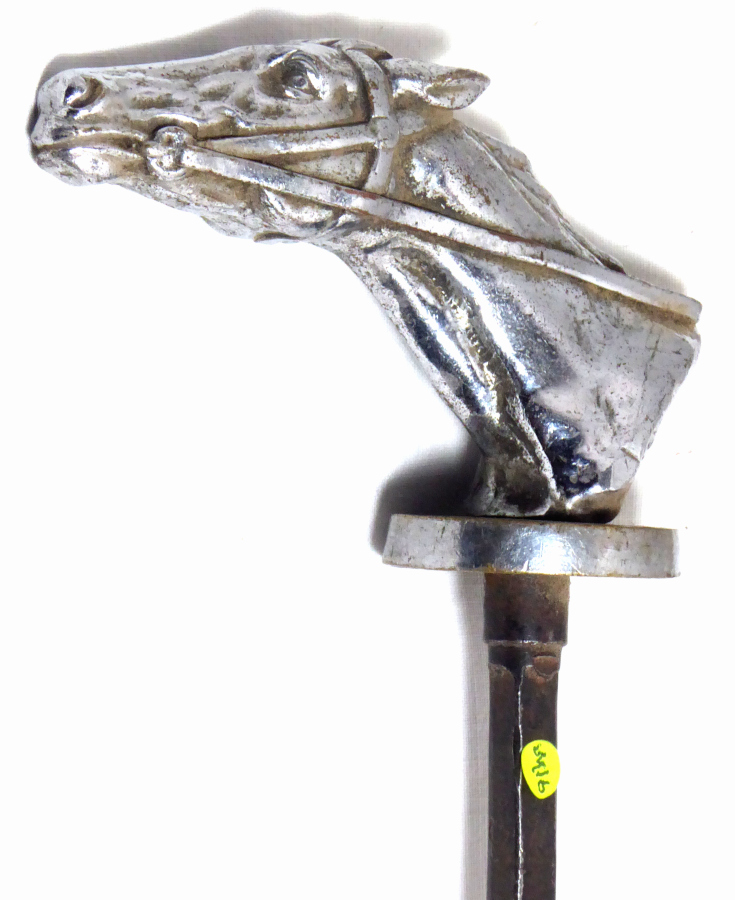 A well-detailed accessory mascot in the form of a horse's head, with long stem.