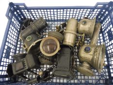 A tray of early acetylene bicycle lamps etc.