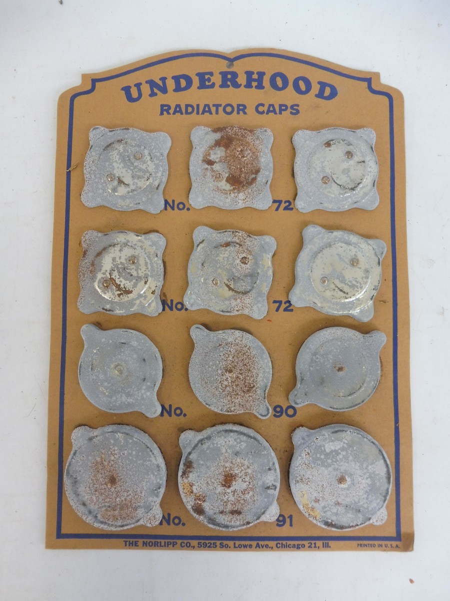 An 'Underhood' American showcard display for different size/type of radiator caps.