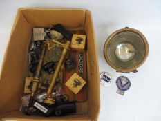 A box of assorted parts to include new old stock parking lamps, plus two ex-WD brass air pumps, a