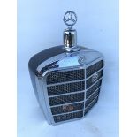 A Mercedes-Benz decanter in the form of a radiator.