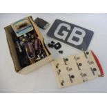 A GB plate and a variety of badge bar fixings, lenses, switches etc.