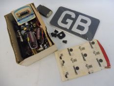 A GB plate and a variety of badge bar fixings, lenses, switches etc.