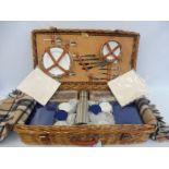 An Optima wicker cased picnic four person set, in excellent condition.