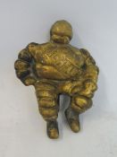A small brass seated Michelin Mr. Bibendum figure.