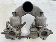 A pair of 1 1/2" SU vertical carburettors, with air cleaning casting.