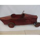 An early Continental tinplate pedal car of streamlined form.