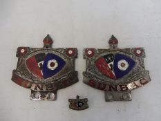 Two Sunbac part enamel badges and a matching lapel badge.