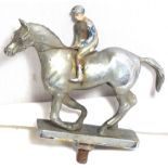 A horse and jockey mascot, with traces of painted finish.