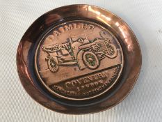 A Daimler embossed copper ashtray.