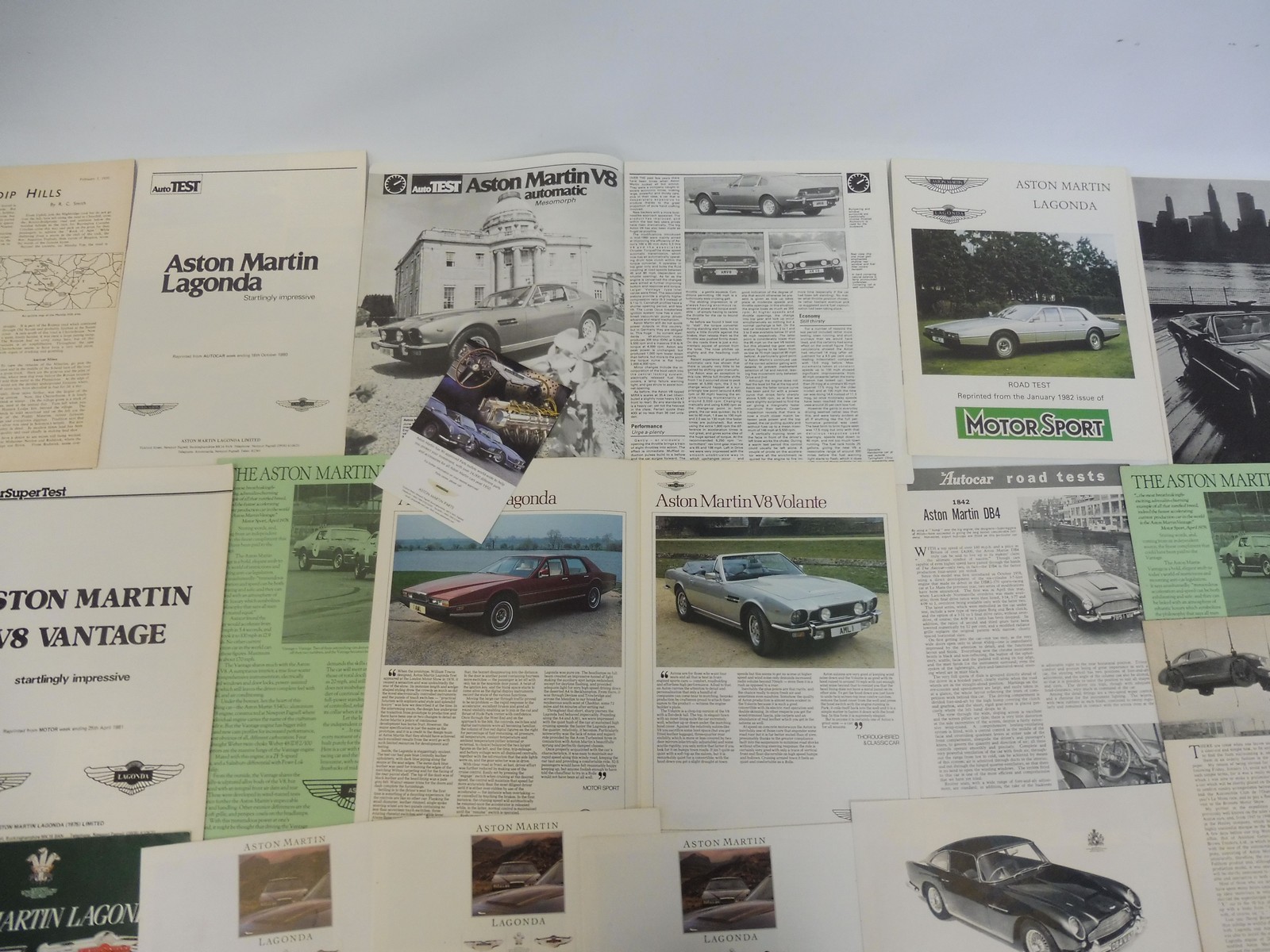 A quantity of Aston Martin brochures and leaflets.