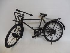 A metal model of a gent's bicycle.