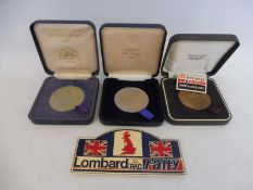 Three Lombard RAC Rally medals for 1984, 1988 and 1993 plus a plastic plaque.