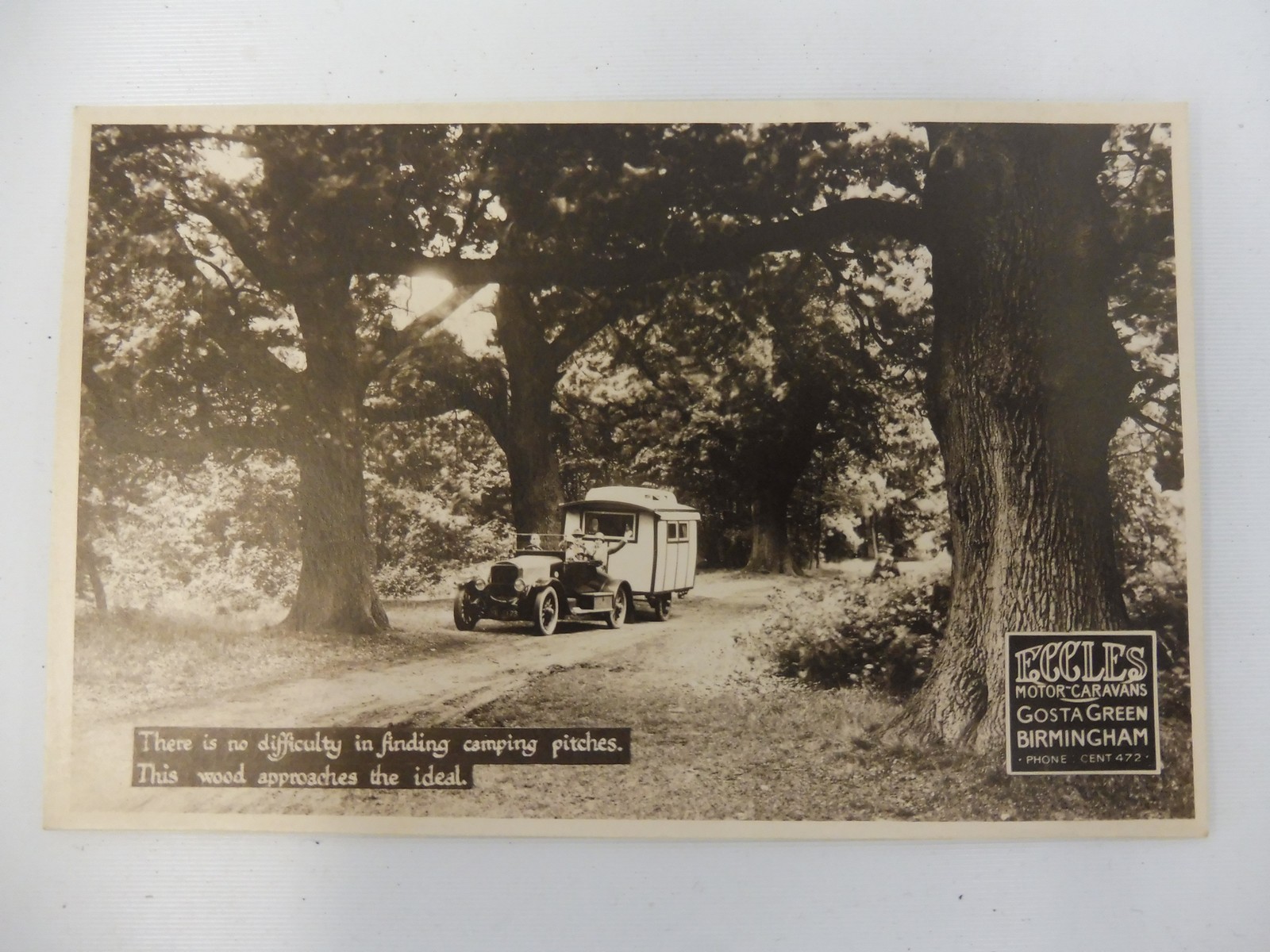 A rare Eccles Caravans pictorial postcard depicting an early vintage car pulling a caravan.